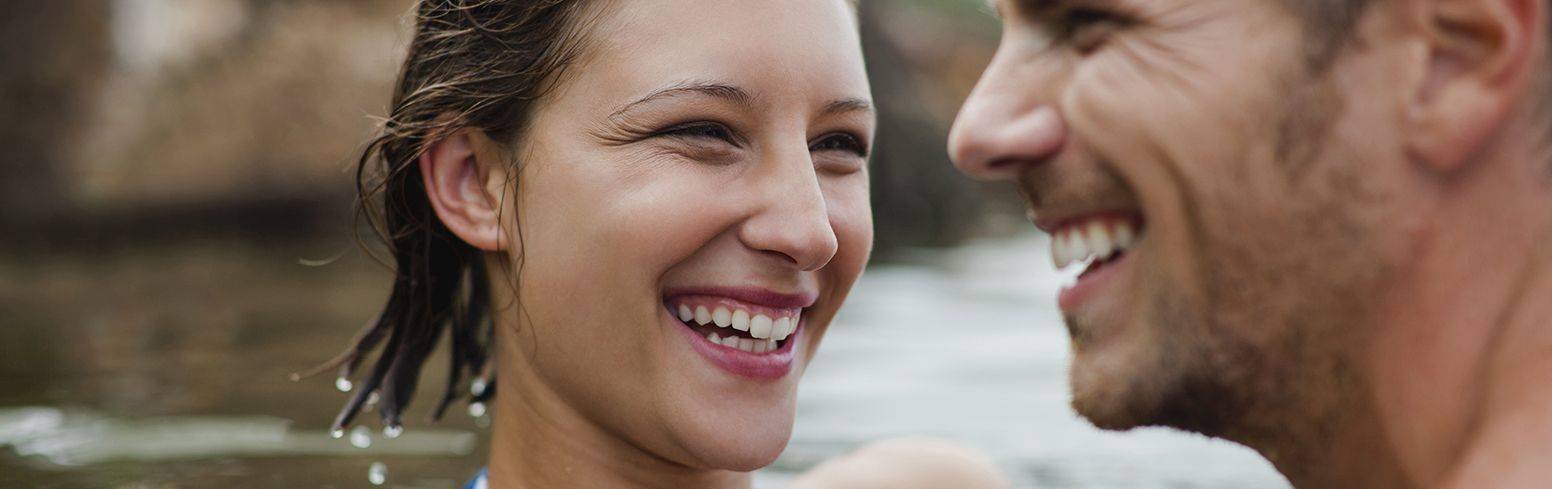 smiling couple swimming in river