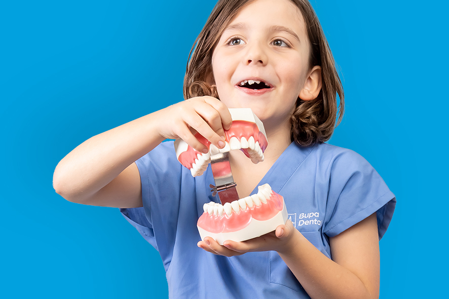 Boy holding fake teeth