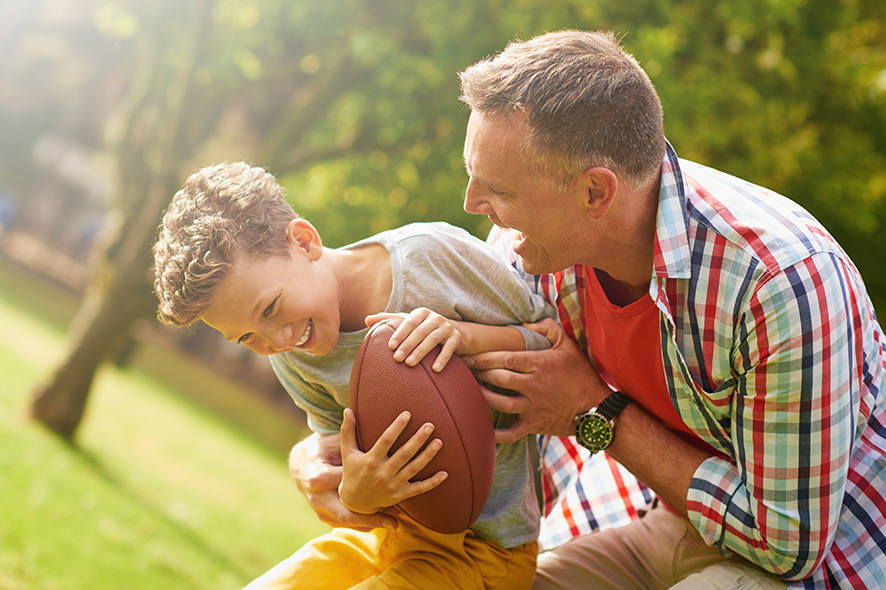 Father and son playing football