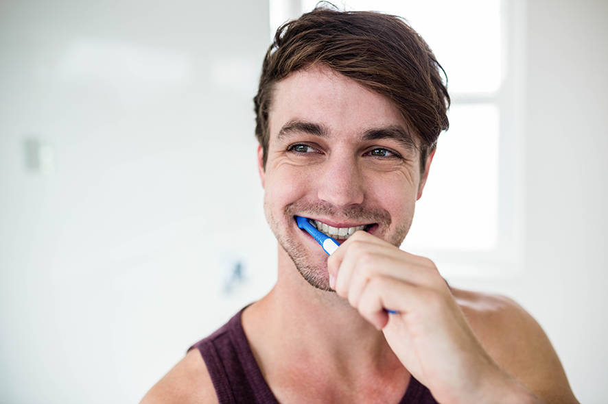 Guy brushing his teeth