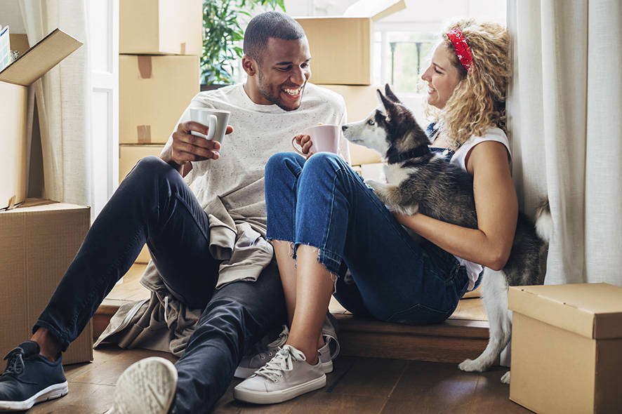 Couple with their dog moving into a new house